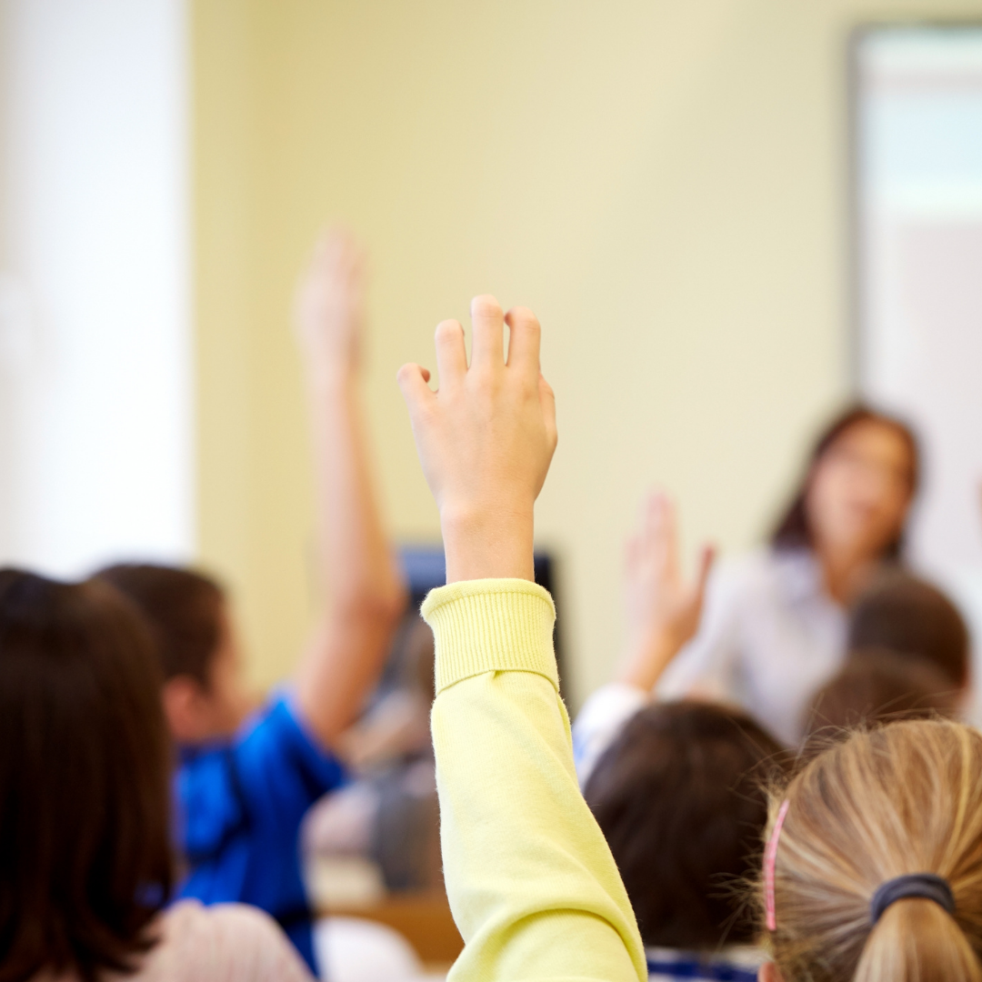 children in Nursery holding up there hands