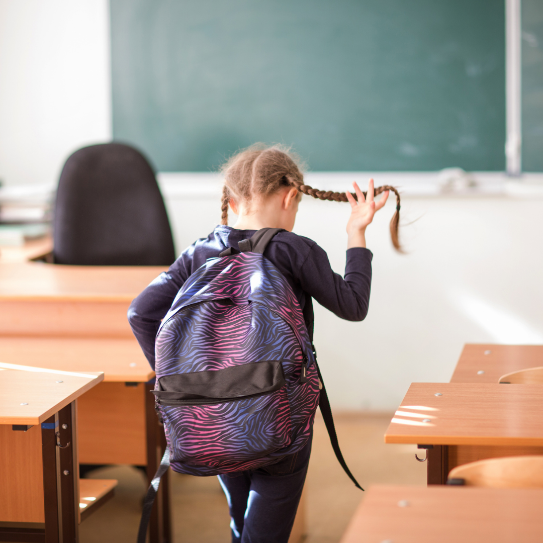 young school girl leaving her class room