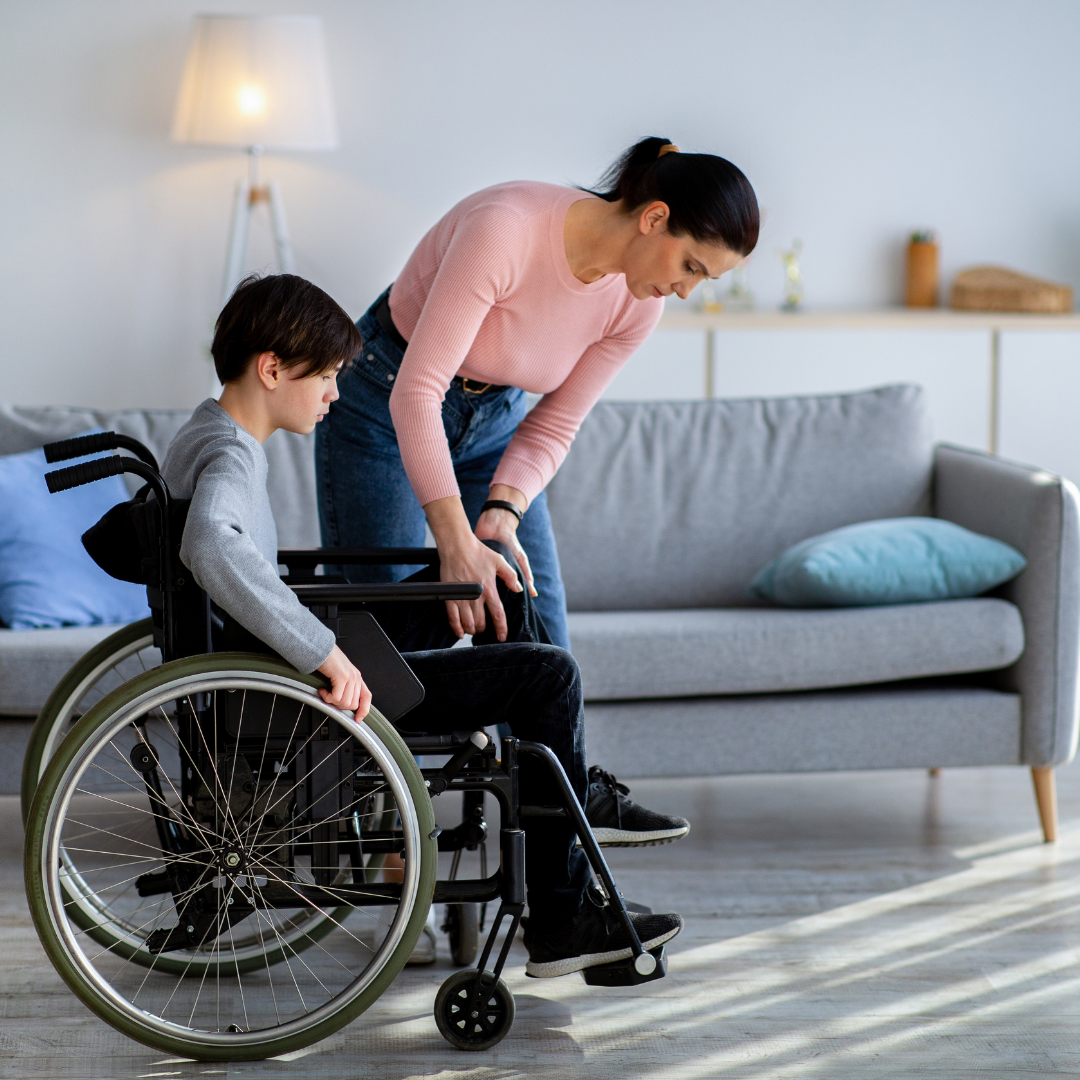 child in wheelchair and getting assisted by woman