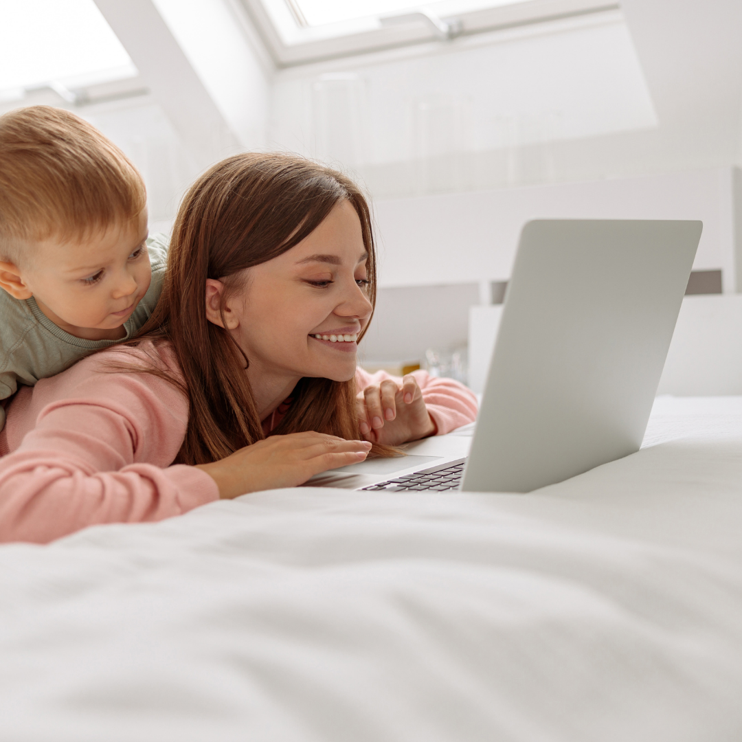 siblings looking on a laptop