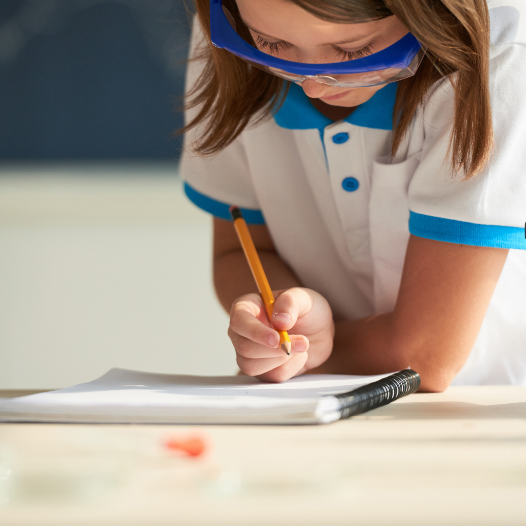 young girl writing something down