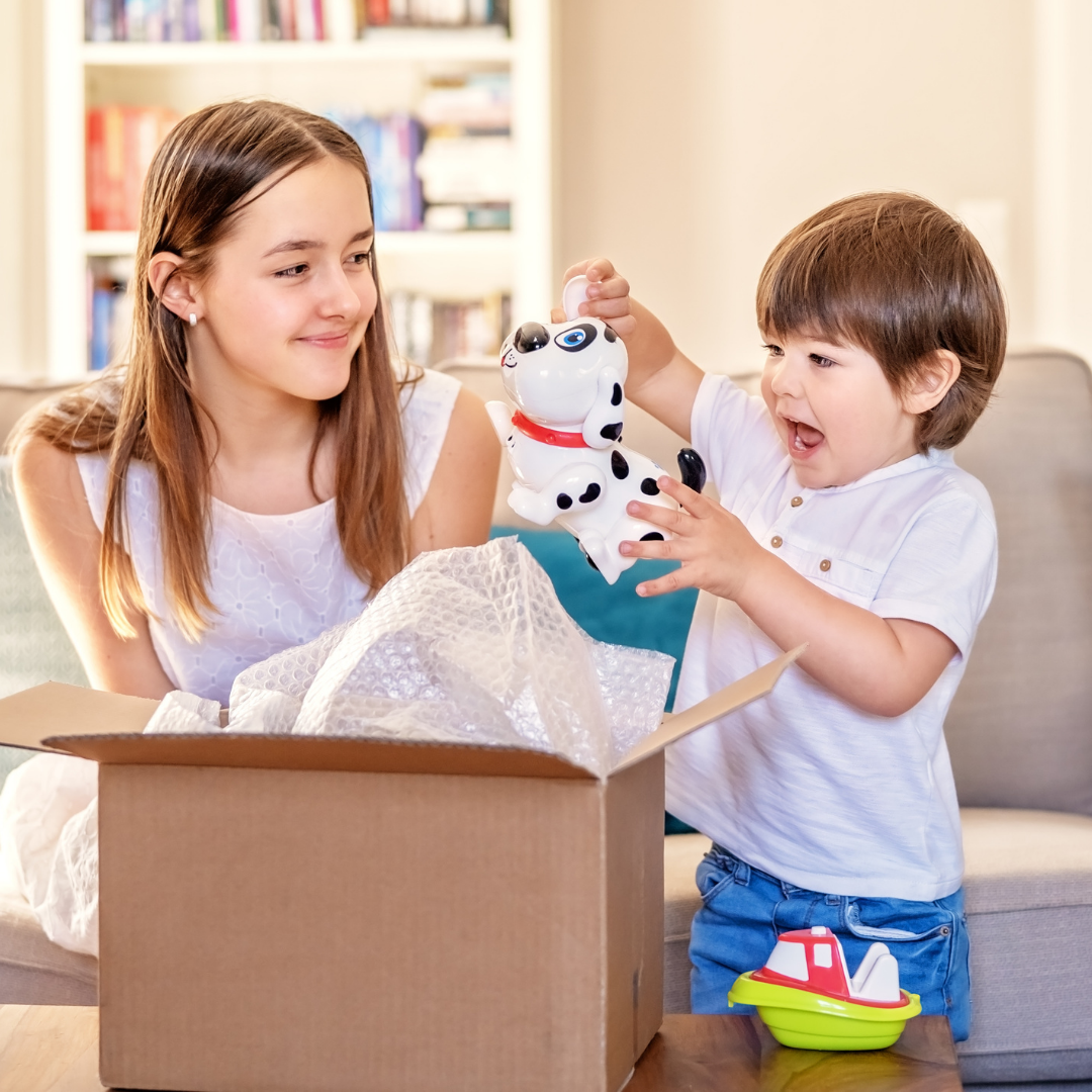 Boy and girl unboxing a box