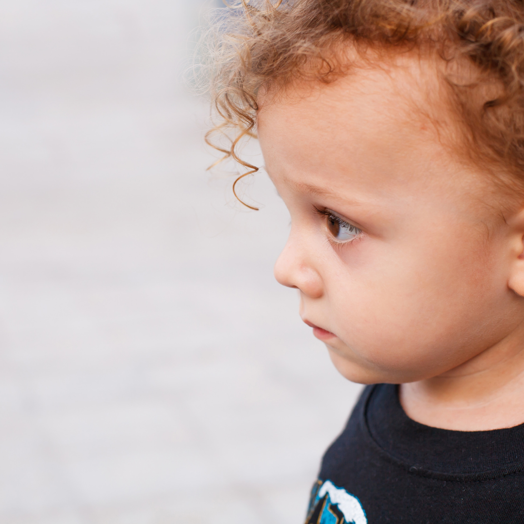 A young boy looking sad