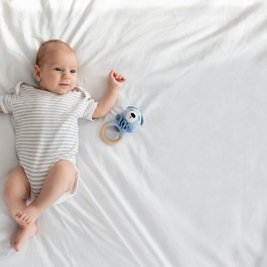 A child laying down on a white bed