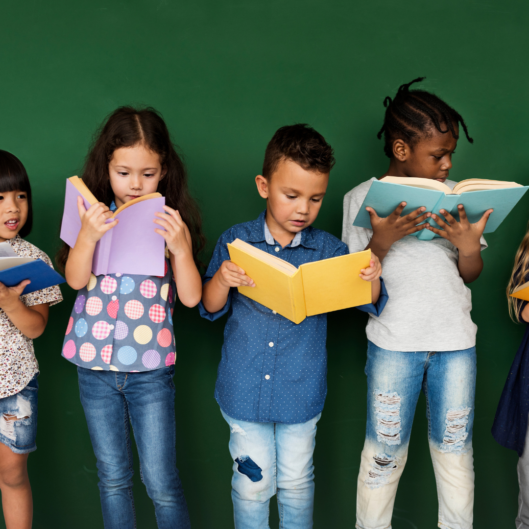 Children reading books along a green background