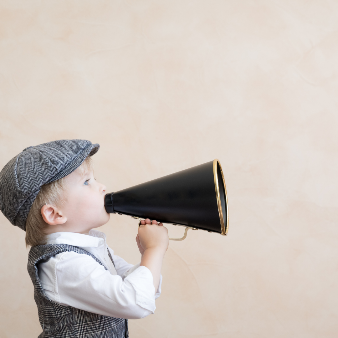 Child talking through a microphone