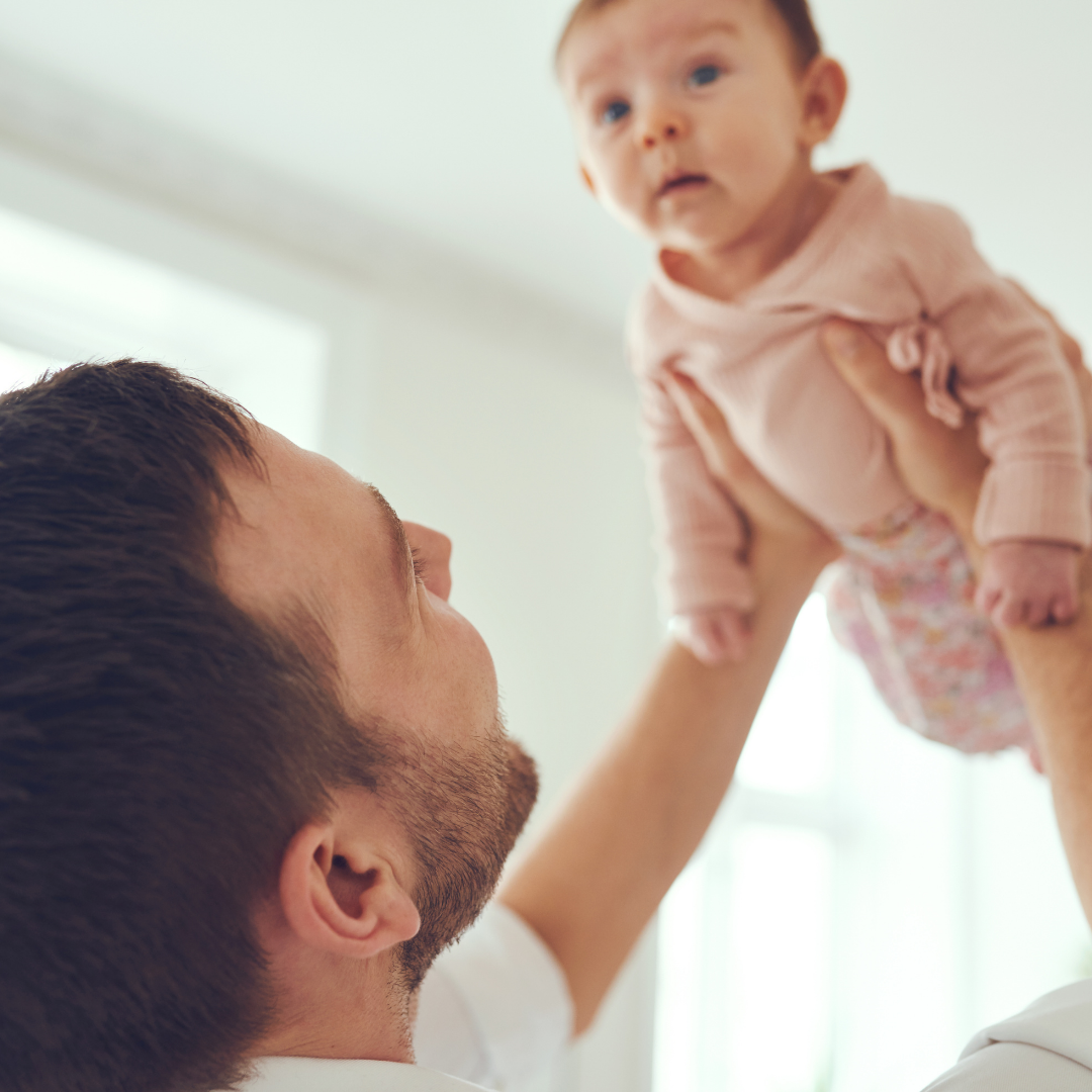 Dad holding a baby