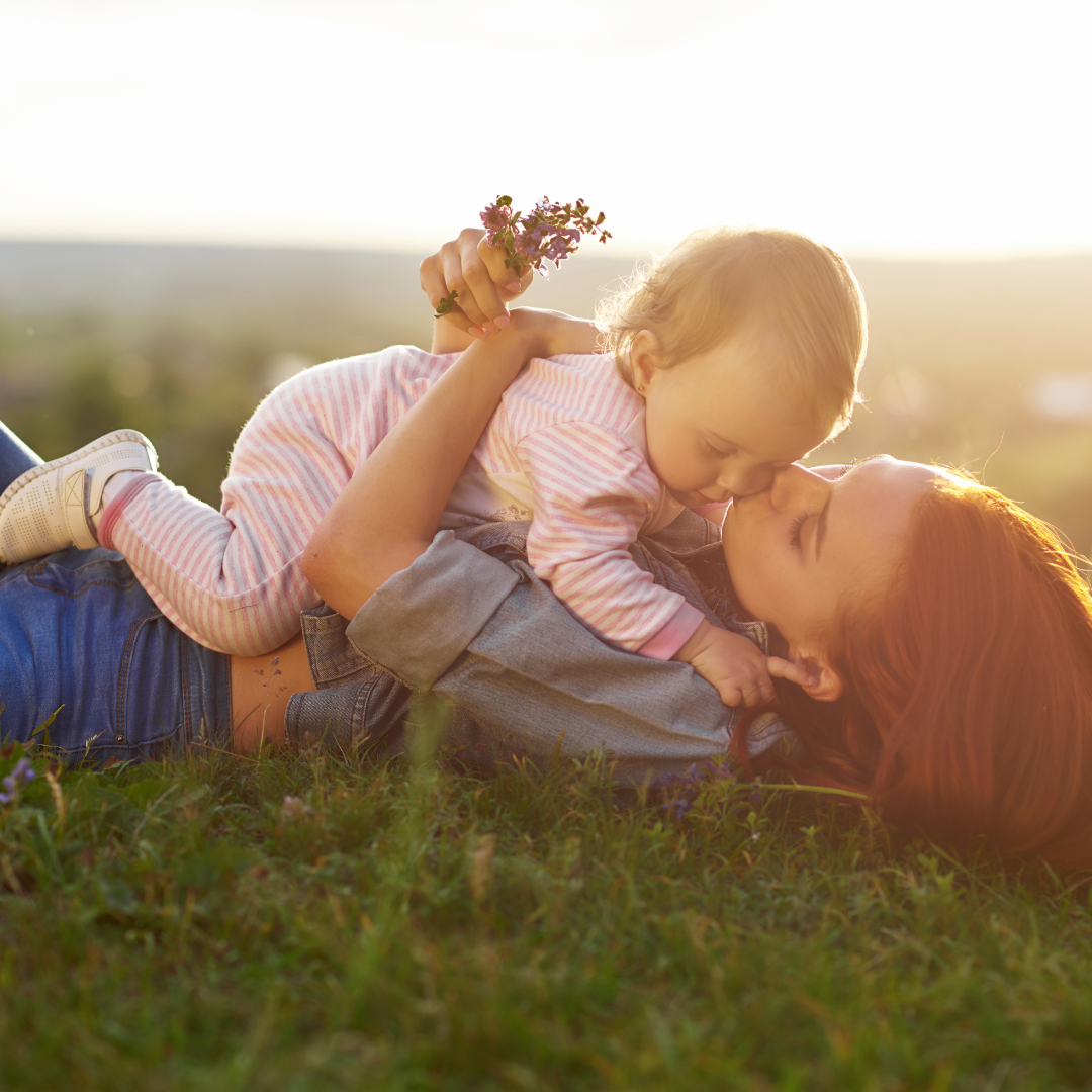 mother and sun laying in a park