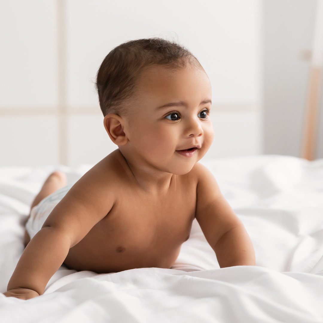 Baby boy walking across bed